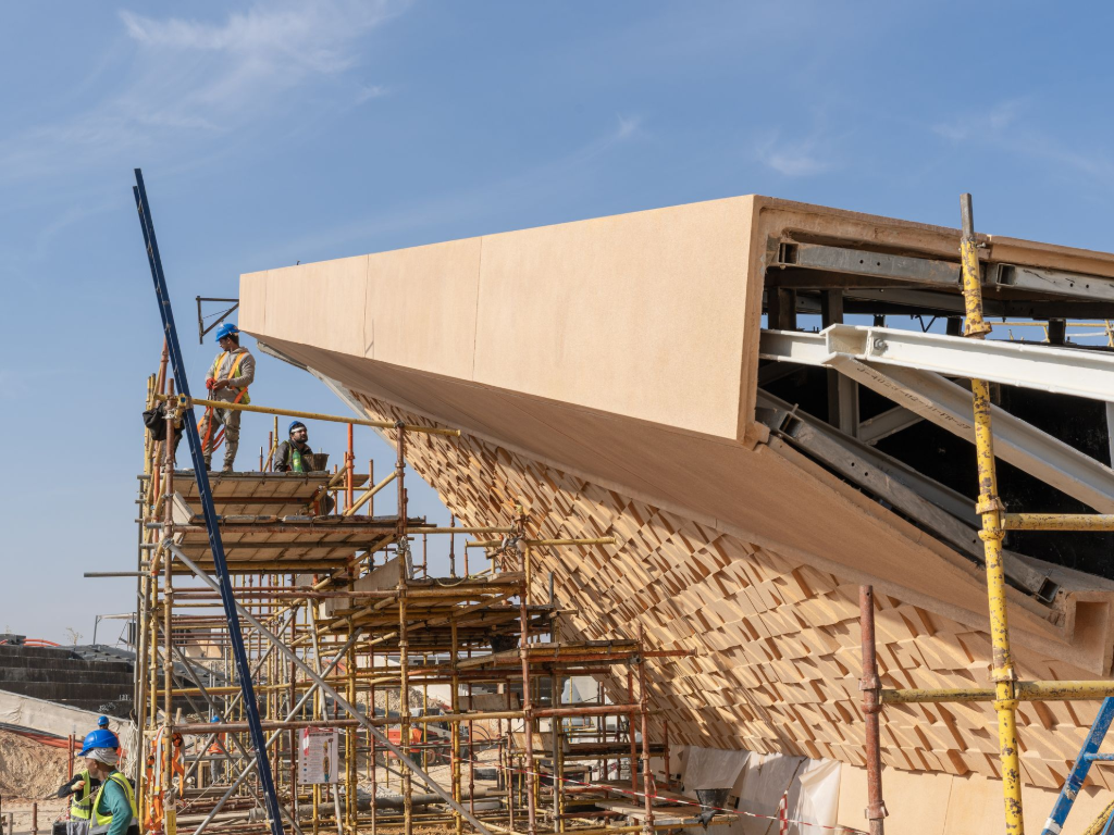 GRC façade installation on scaffolding during large-scale construction project in Saudi Arabia.