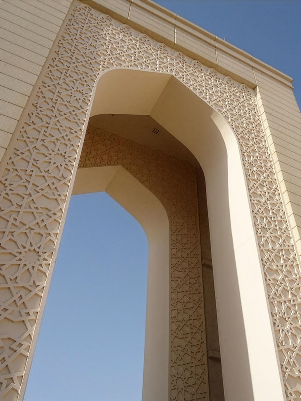 Close-up of GRC façade arch with textured surface and precision moulded details