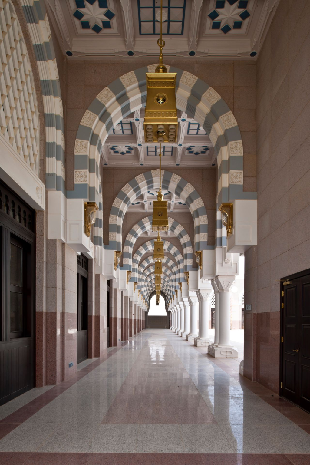 Decorative GRG interior corridor with arches, columns, and patterned ceilings in a Saudi mosque
