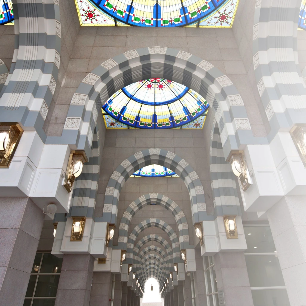 Architectural interior with circular dome and stained-glass skylight featuring intricate GRC and GRG details