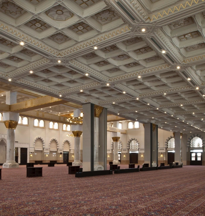Custom joinery and decorative ceiling elements installed in a mosque interior.